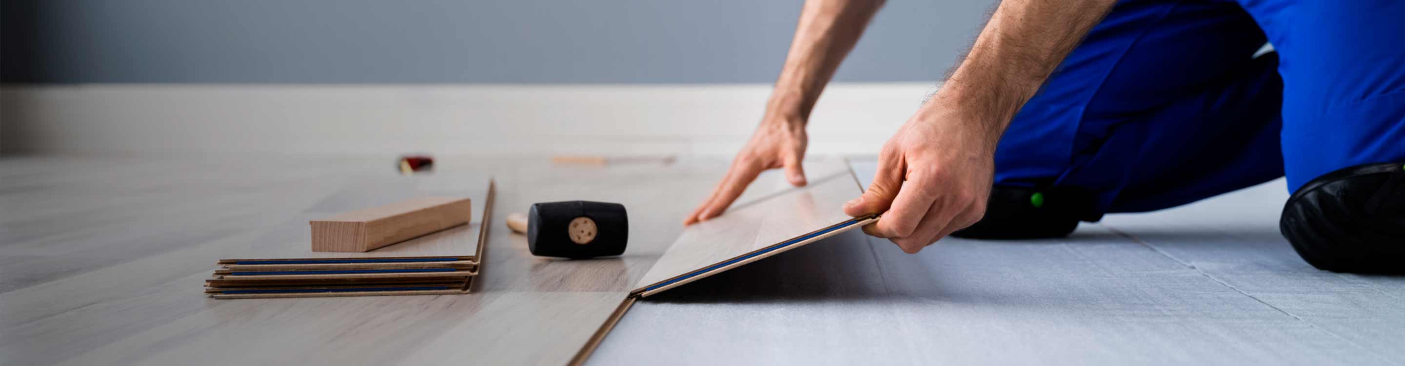 flooring expert installing wooden plank floors.